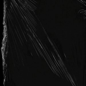 Abstract plastic wrap texture with dramatic lighting on a black surface.