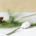 Dynamic close-up of various spices and powders on spoons, emphasizing vibrant colors.
